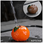 Farbwechselndes Teetier aus Kunstharz — Orange mit grünem Blatt