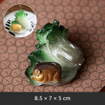 Teetier mit Kohlmotiv und Schwein aus Kunstharz